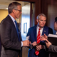 Sen. John Thune (R-SD) (L) and Sen. Rob Portman (R-OH) (C) talk with an aide before a press conference at the US Capitol on April 27, 2022 in Washington, DC